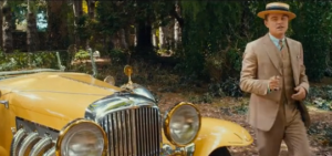 Jay with yellow car The Great Gatsby 2013 - fashion in film.PNG